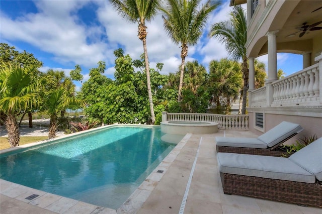 view of swimming pool featuring a patio area and an in ground hot tub