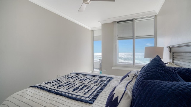 bedroom featuring ceiling fan, a water view, and ornamental molding