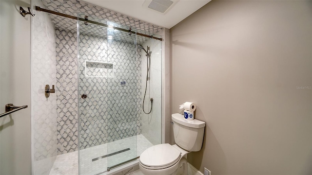 bathroom with toilet and walk in shower