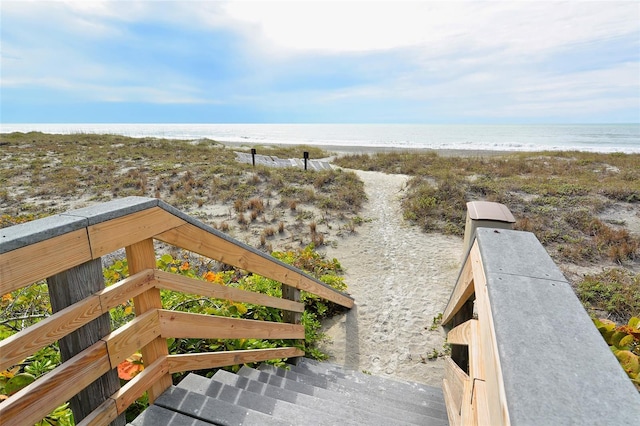 view of property's community featuring a water view and a view of the beach