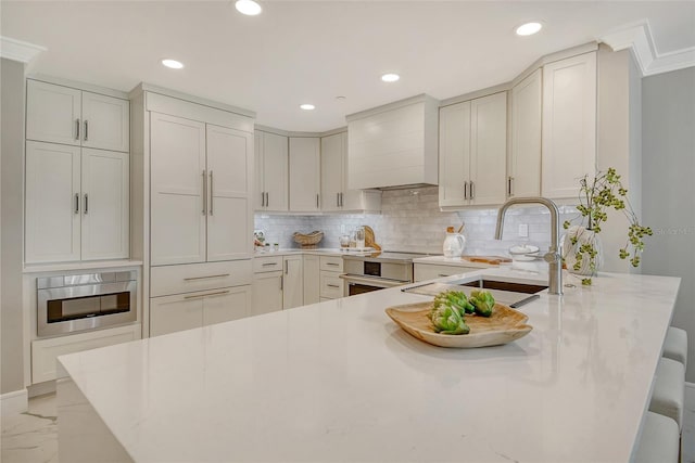 2105 Gulf Of Mexico Dr Unit 3303, Longboat Key, FL 34228 - kitchen with custom exhaust hood, a peninsula, backsplash, light marble finish flooring, and recessed lighting