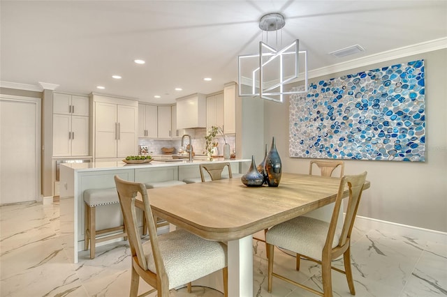 2105 Gulf Of Mexico Dr Unit 3303, Longboat Key, FL 34228 - dining room featuring light marble finish flooring, a chandelier, recessed lighting, and crown molding