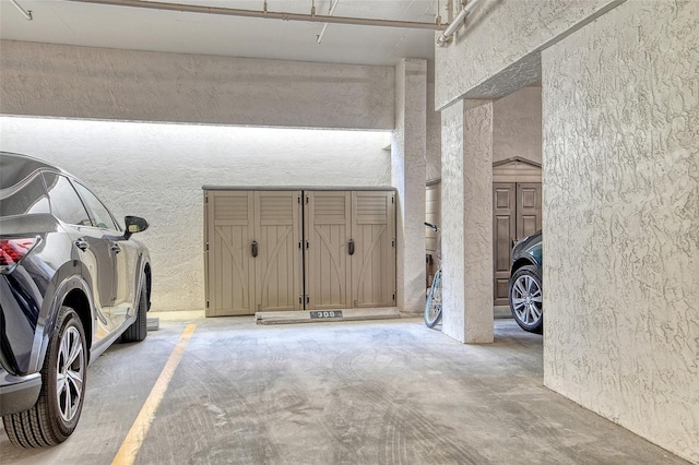 2105 Gulf Of Mexico Dr Unit 3303, Longboat Key, FL 34228 - parking deck featuring a textured wall