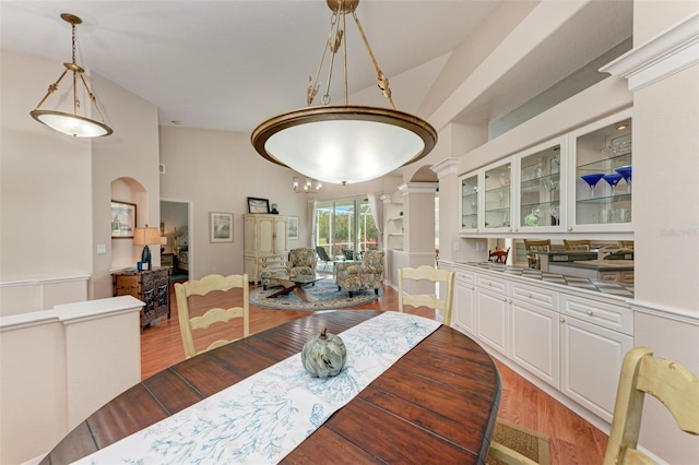 dining area with hardwood / wood-style flooring and lofted ceiling