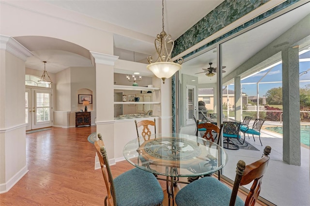 dining room with a wealth of natural light, french doors, light hardwood / wood-style floors, and ceiling fan