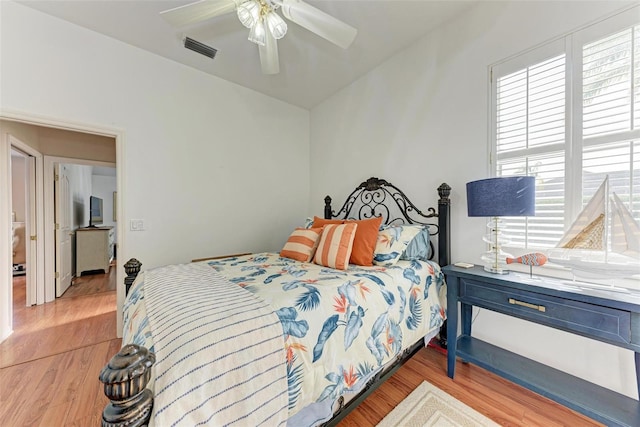 bedroom featuring multiple windows, ceiling fan, and light hardwood / wood-style flooring