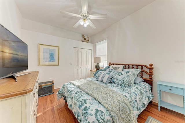 bedroom with ceiling fan, a closet, and light hardwood / wood-style flooring