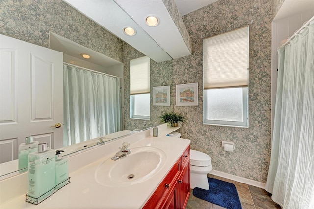 bathroom featuring tile patterned flooring, vanity, and toilet