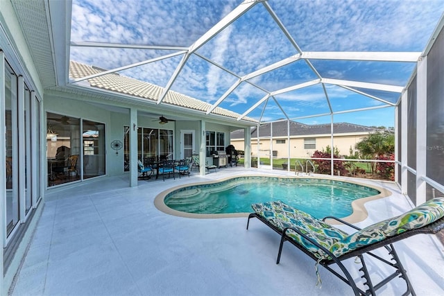 view of pool featuring a patio area, ceiling fan, and glass enclosure