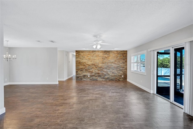 unfurnished living room with dark hardwood / wood-style flooring, ceiling fan with notable chandelier, and a textured ceiling