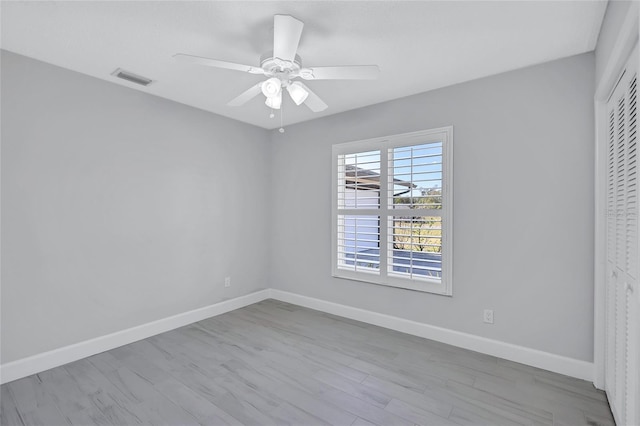 spare room featuring ceiling fan and light hardwood / wood-style floors