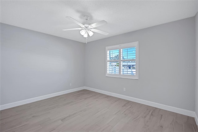 empty room featuring ceiling fan and light hardwood / wood-style flooring