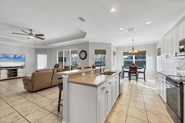 kitchen featuring white cabinets, sink, stainless steel appliances, and hanging light fixtures