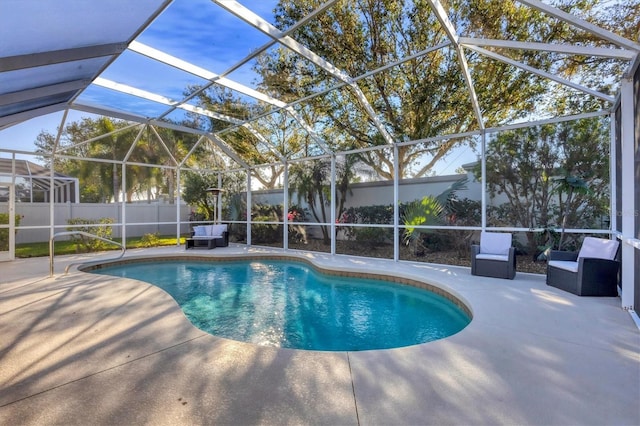 view of swimming pool featuring glass enclosure and a patio