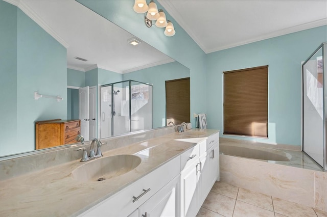 bathroom with a stall shower, tile patterned flooring, a sink, and a garden tub