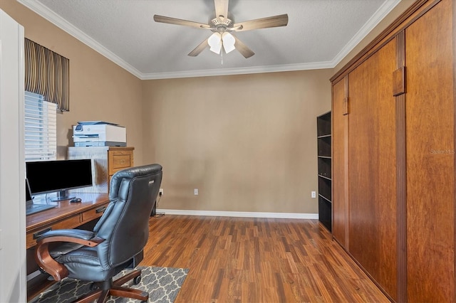 office space featuring baseboards, a ceiling fan, dark wood-style floors, ornamental molding, and a textured ceiling