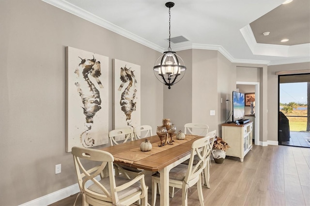11265 Mc Dermott Ct, Englewood, FL 34223 - dining area featuring light wood-style floors, a chandelier, and ornamental molding