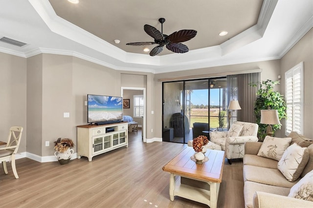 11265 Mc Dermott Ct, Englewood, FL 34223 - living area with a raised ceiling, ceiling fan, light wood-style floors, ornamental molding, and recessed lighting