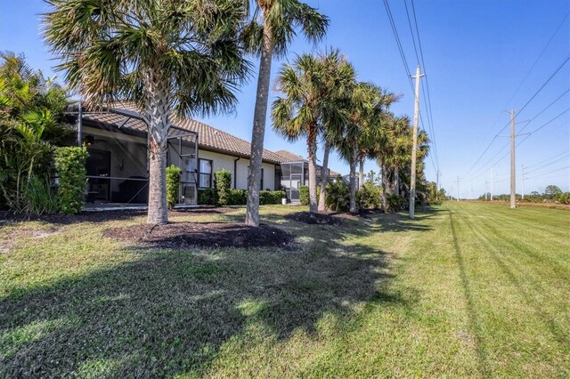 11265 Mc Dermott Ct, Englewood, FL 34223 - view of grassy yard with a lanai