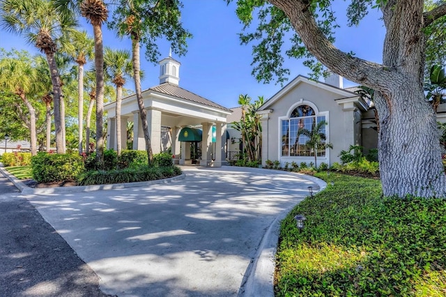 11265 Mc Dermott Ct, Englewood, FL 34223 - view of front facade featuring curved driveway and stucco siding