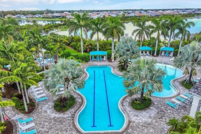 view of pool with a patio and a water view