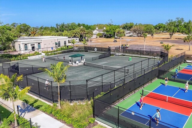 11265 Mc Dermott Ct, Englewood, FL 34223 - view of tennis court with view of scattered trees