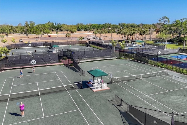 11265 Mc Dermott Ct, Englewood, FL 34223 - view of tennis court featuring view of wooded area