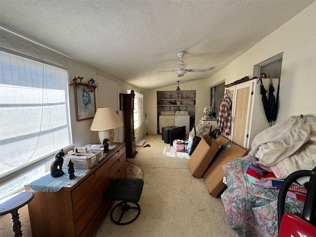 living room with lofted ceiling, light carpet, ceiling fan, separate washer and dryer, and a textured ceiling