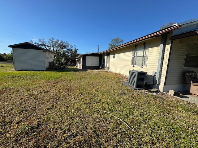 view of yard featuring a storage unit and cooling unit