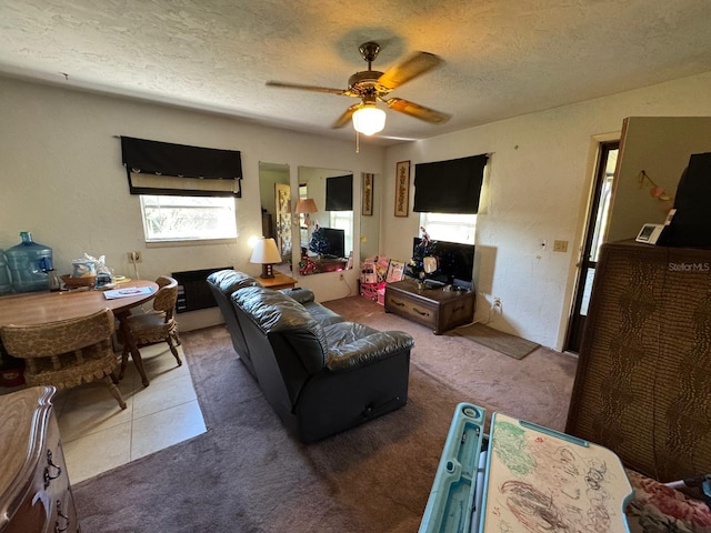 living room featuring carpet, a textured ceiling, and ceiling fan