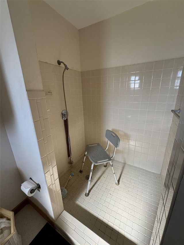 bathroom featuring tile patterned floors and tiled shower