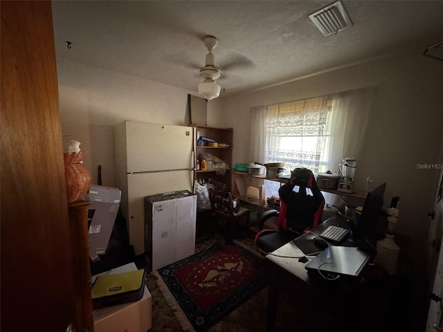 office space with ceiling fan and a textured ceiling