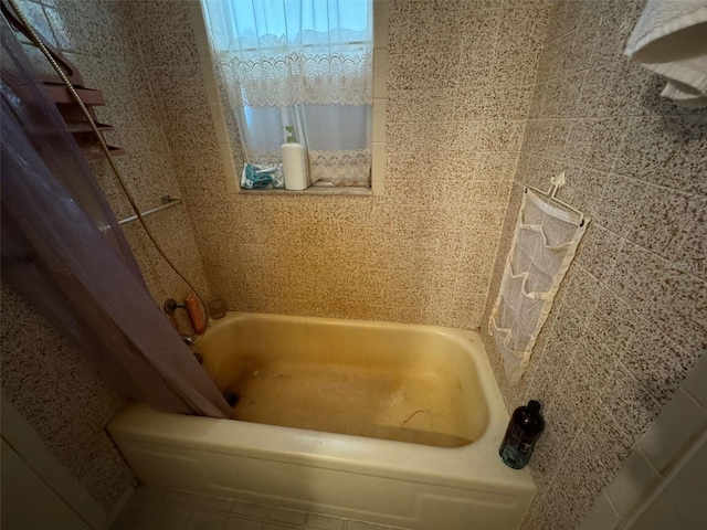 bathroom featuring shower / bathtub combination with curtain