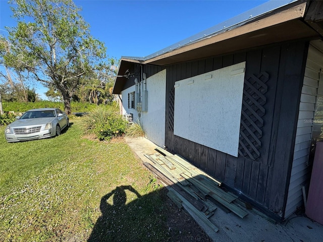 view of side of home featuring a lawn