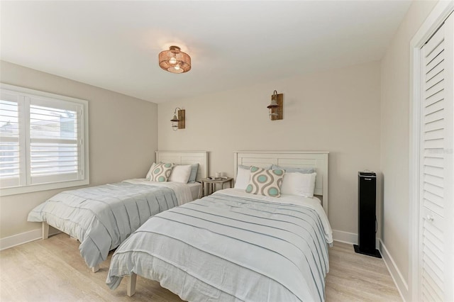 bedroom featuring light wood-type flooring and a closet