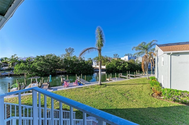 view of yard featuring a water view and a dock