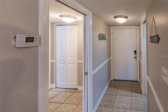 doorway with light tile patterned floors