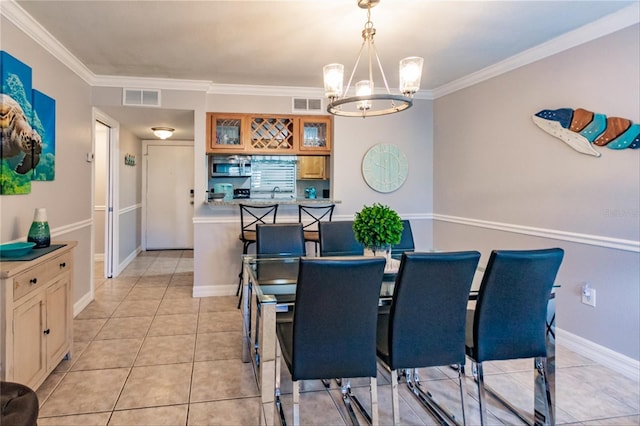 tiled dining space with an inviting chandelier, ornamental molding, and sink