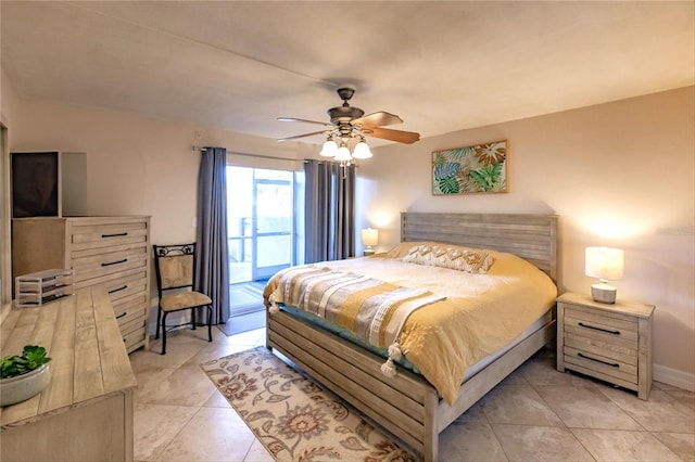 tiled bedroom with access to outside and ceiling fan