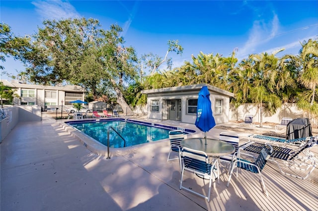 view of pool with an outdoor structure and a patio