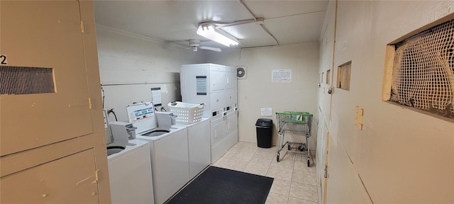 clothes washing area featuring light tile patterned floors, washing machine and dryer, and ceiling fan