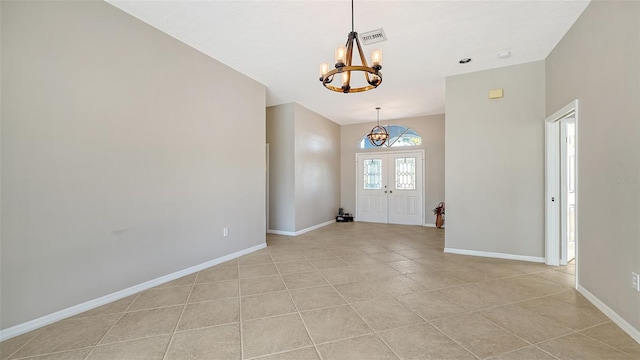 tiled foyer with a notable chandelier