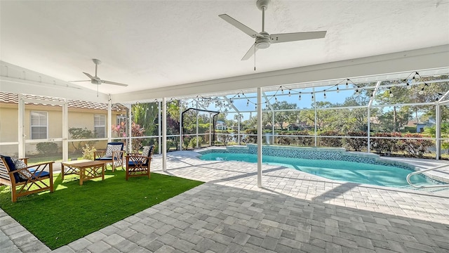 view of pool featuring ceiling fan, a patio area, and a lanai