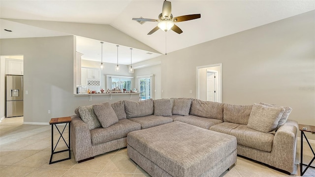 tiled living room featuring ceiling fan and lofted ceiling