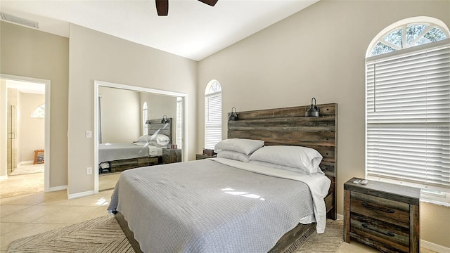 bedroom featuring vaulted ceiling, ceiling fan, and light tile patterned flooring