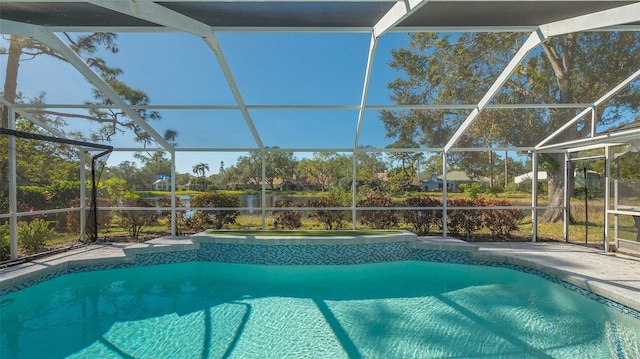 view of swimming pool with an in ground hot tub and a lanai