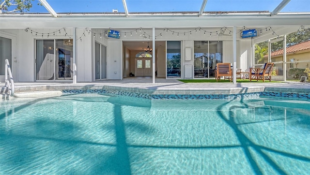 view of pool with a patio area and a lanai