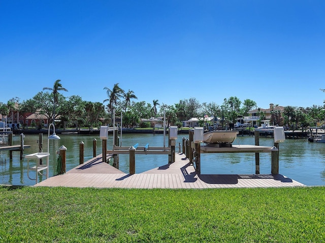 view of dock featuring a lawn and a water view