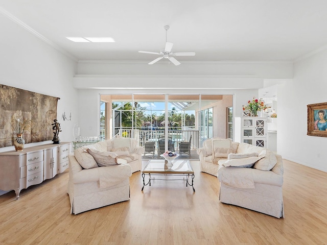 living room featuring light wood-type flooring, ceiling fan, and crown molding