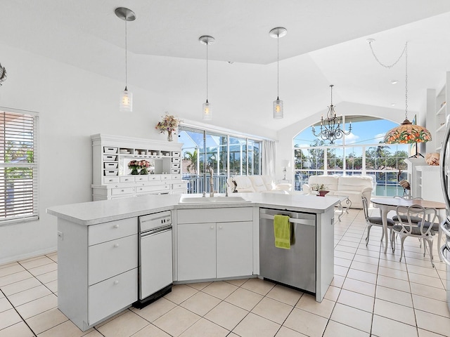 kitchen with vaulted ceiling, decorative light fixtures, dishwasher, a chandelier, and white cabinetry